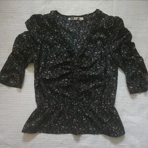 Black floral peplum top with ruffle details